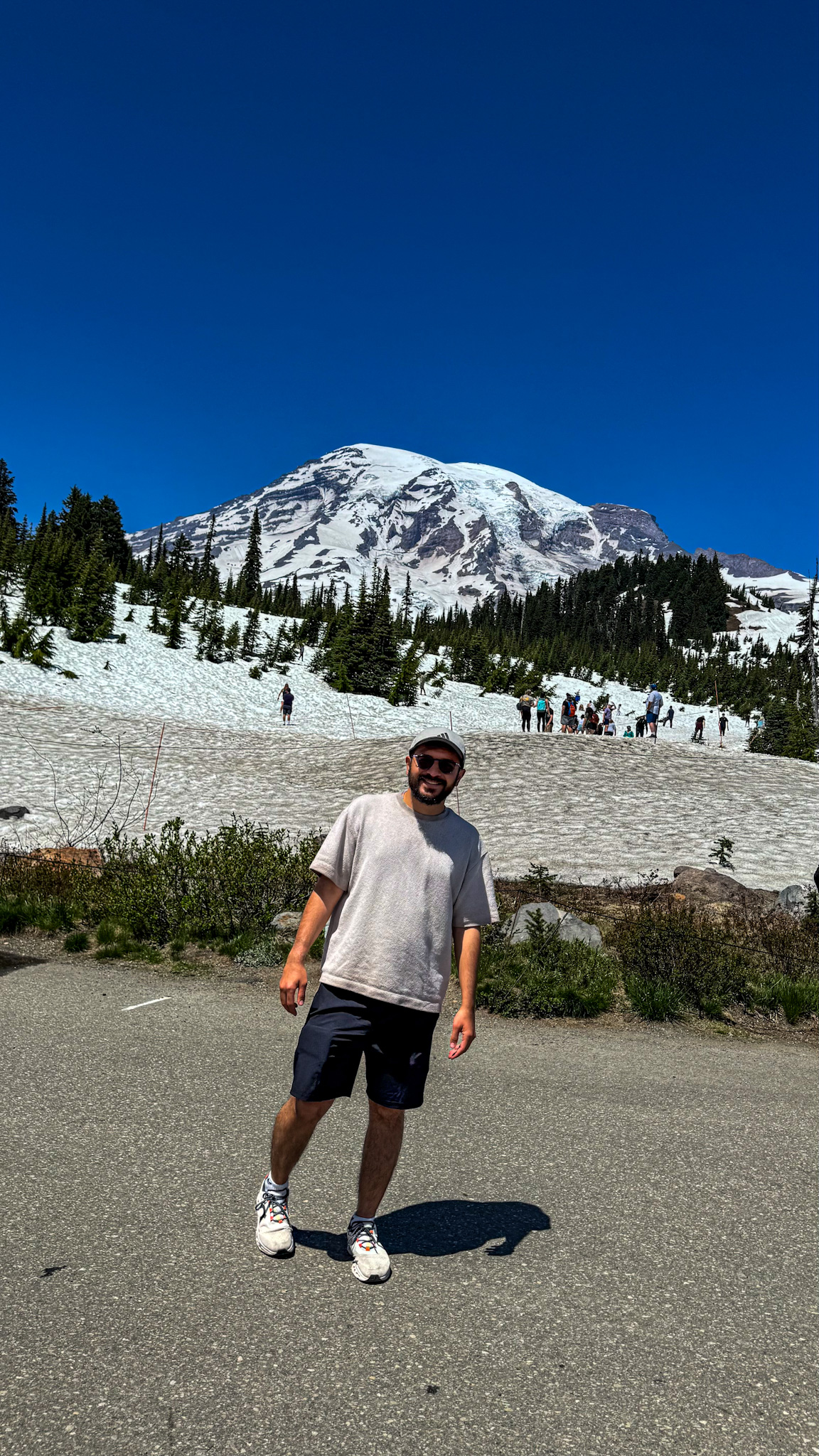 Visitors in snow at Paradise with Mount Rainier in the background, Mount Rainier National Park.