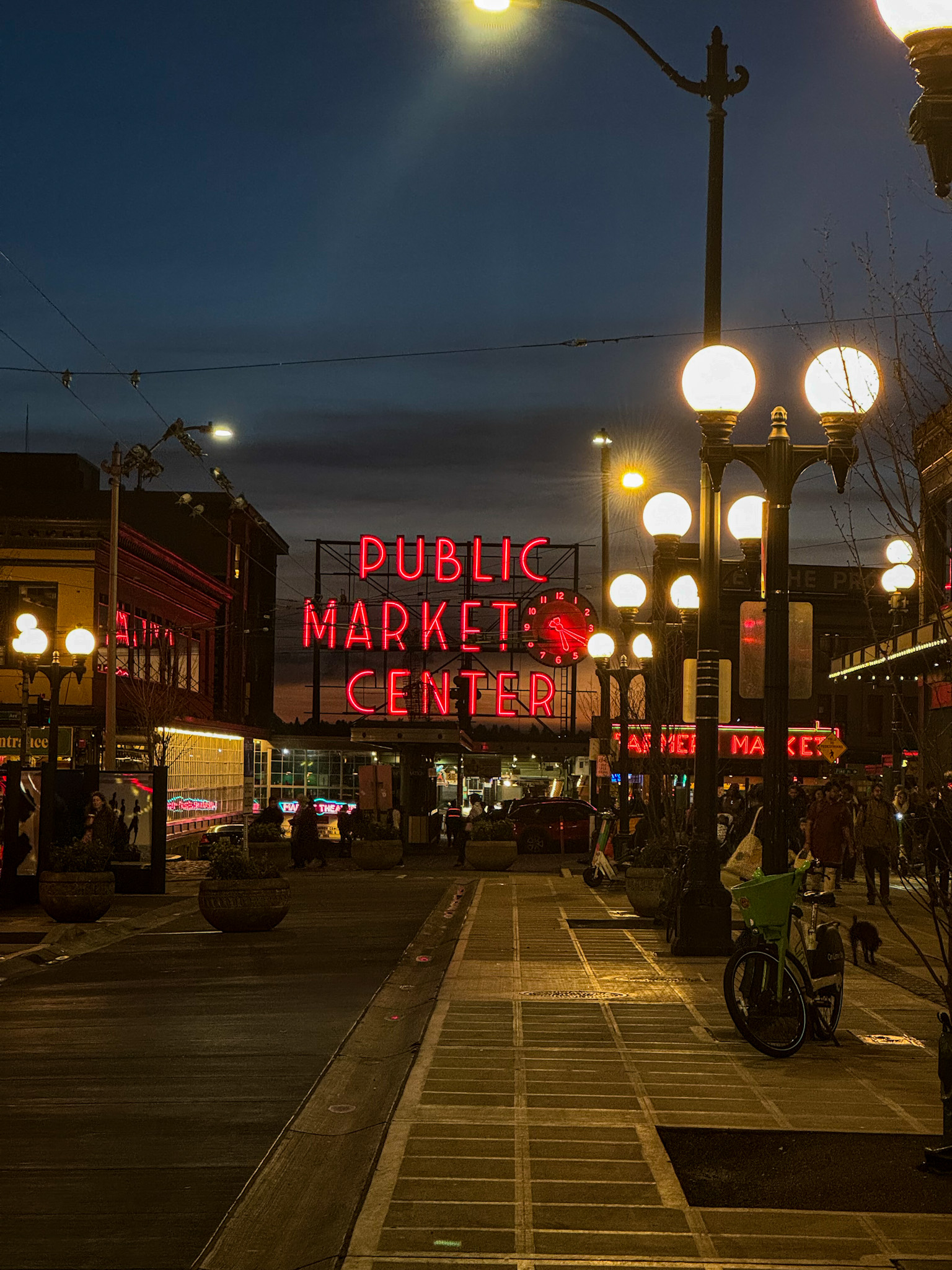 Neon Public Market Center sign glowing at Pike Place Market in Seattle at night.