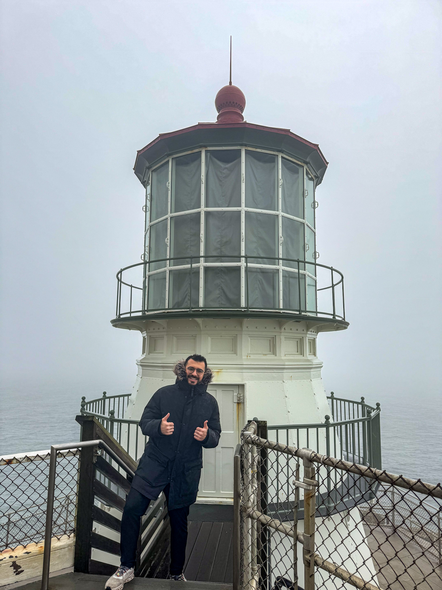 Traveler standing near Heceta Head Lighthouse on the Oregon Coast in Oregon.
