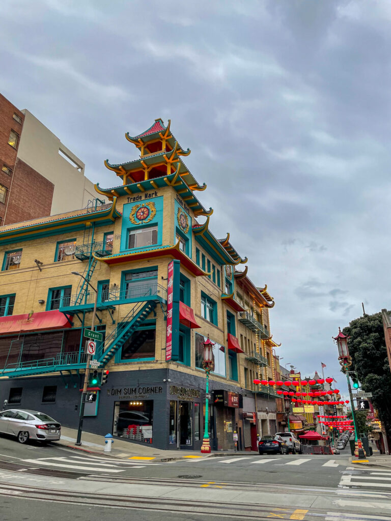 Colorful Chinatown street in San Francisco with lanterns and traditional Chinese-style architecture.