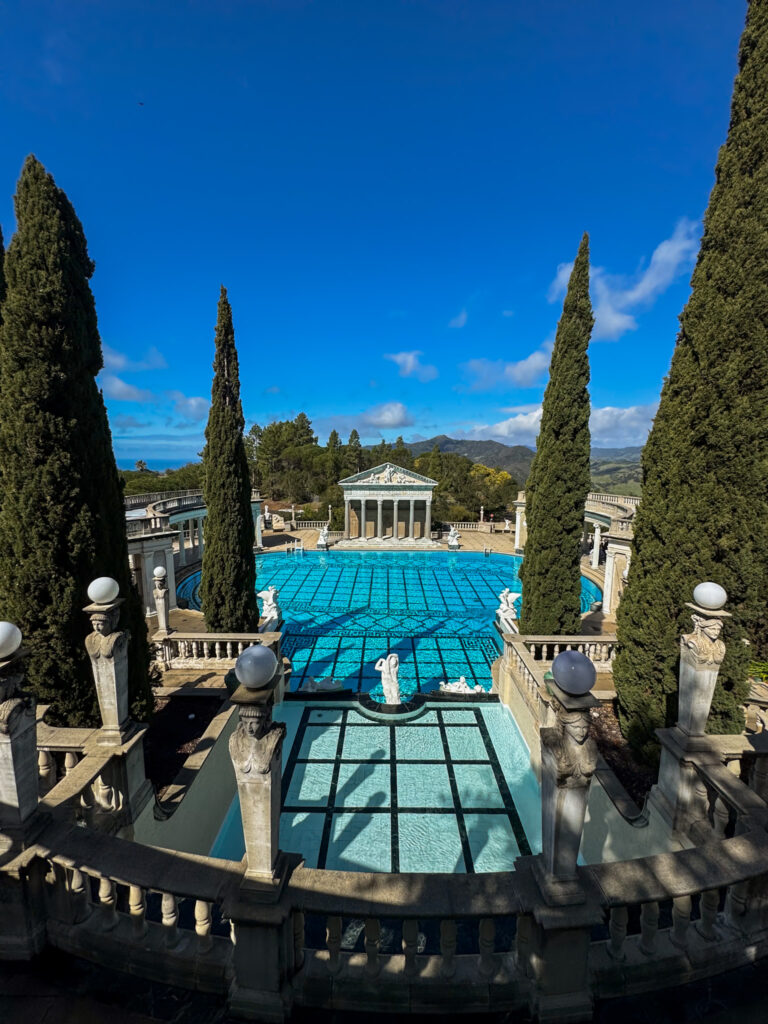 The famous Neptune Pool at Hearst Castle with blue water and Roman-inspired architecture.