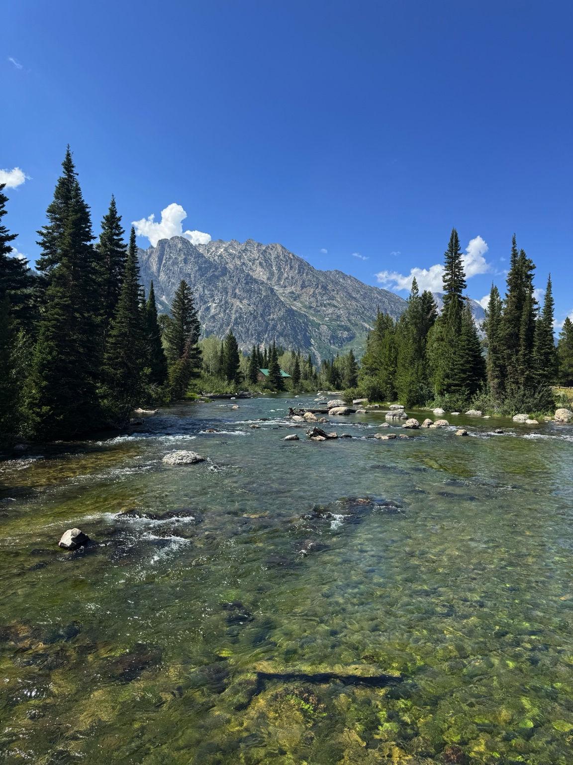 Crystal-clear Snake River flowing beneath the Teton Range in Grand Teton National Park, Wyoming.