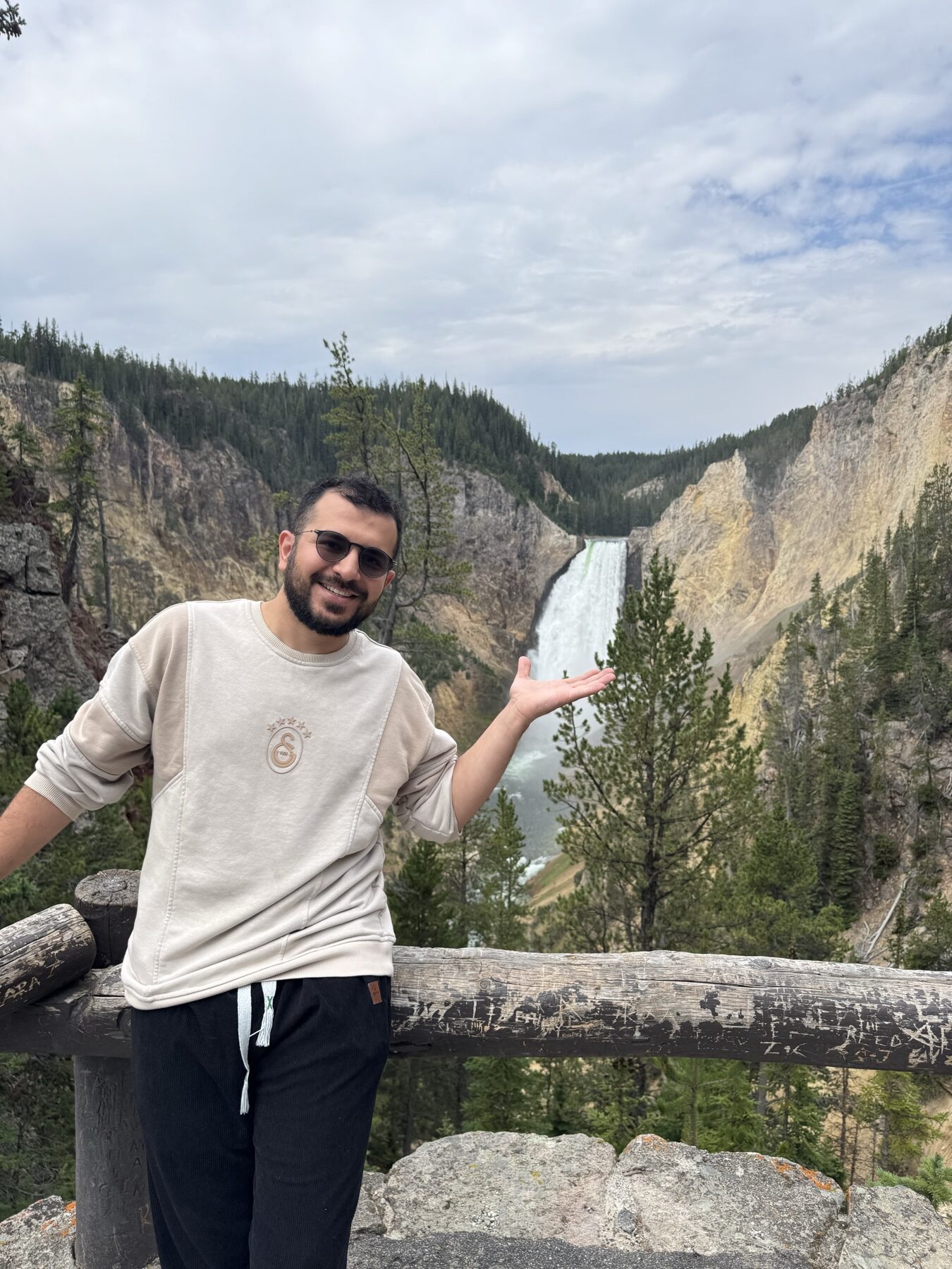 Traveler at a Lower Falls viewpoint in the Grand Canyon of Yellowstone
